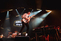 Arkells lead singer Max Kerman plays guitar in front of the Vancouver crowd